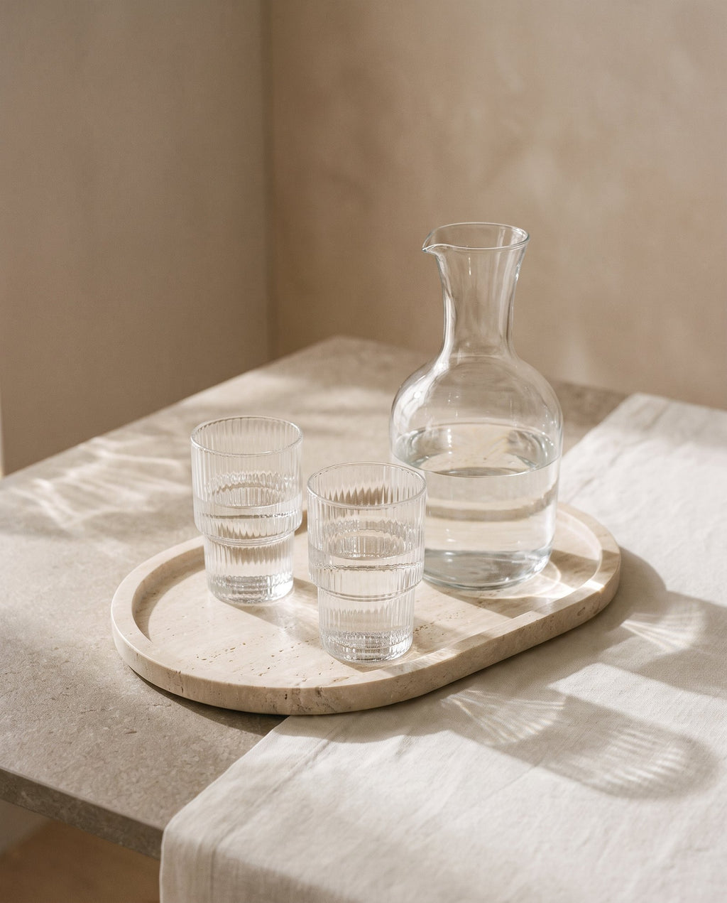 Carafe and tumblers on a travertine tray
