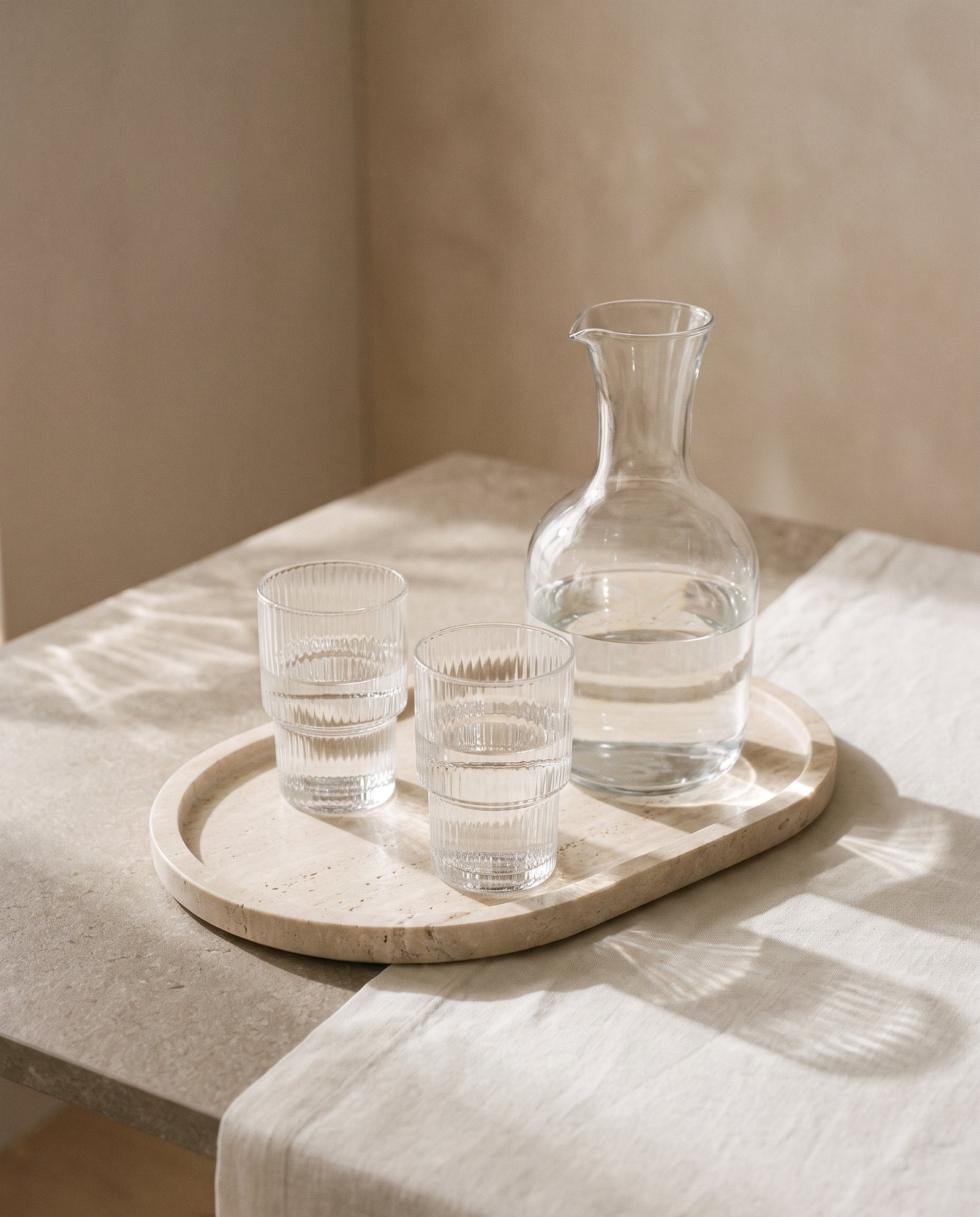 Carafe and tumblers on a travertine tray